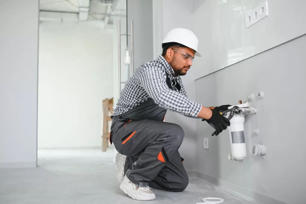 Indian plumber installs change water filter