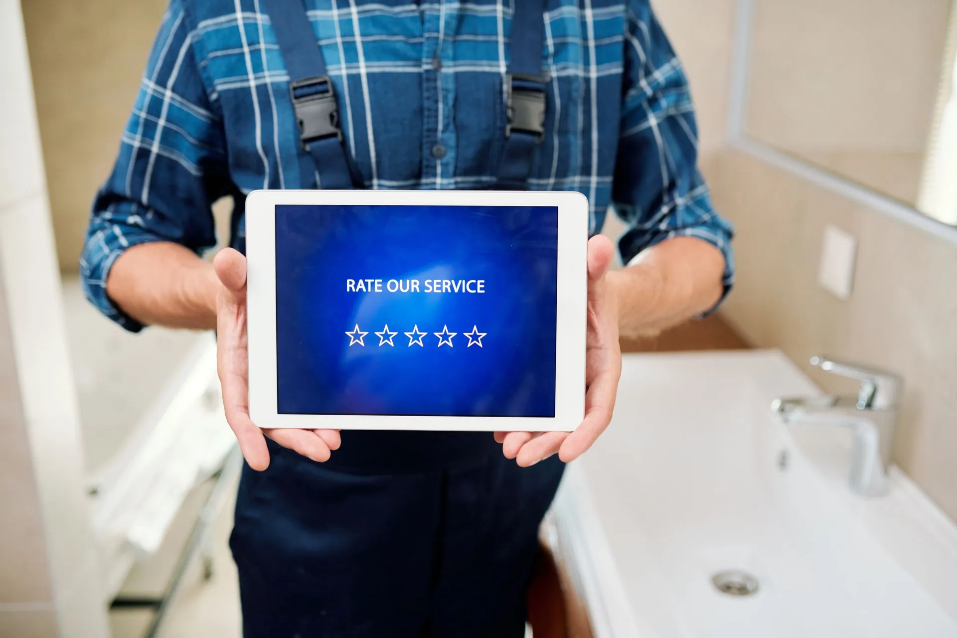Technician worker contemporary household maintenance service holding touchpad with rate screensaver display