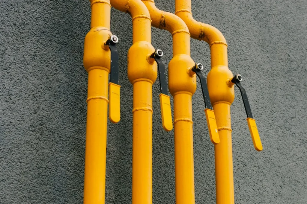yellow-gas-pipe-with-crane-goes-along-facade-new-multi-storey-building